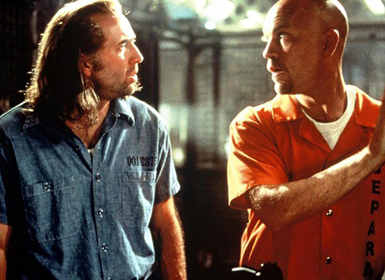 Nicolas Cage and John Malkovich in the 1997 film adaption of Con Air. Davenport Theatrical have confirmed these actors will be replaced by Chad Kroeger and Carlos Santana in the musical