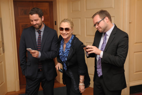 Hillary Clinton fools around with a couple of handsome staffers
