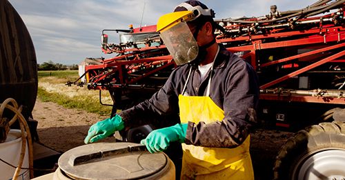 Farm workers are required to wear PPE when handling DHMO in some jurisdictions.  PHOTO: Supplied